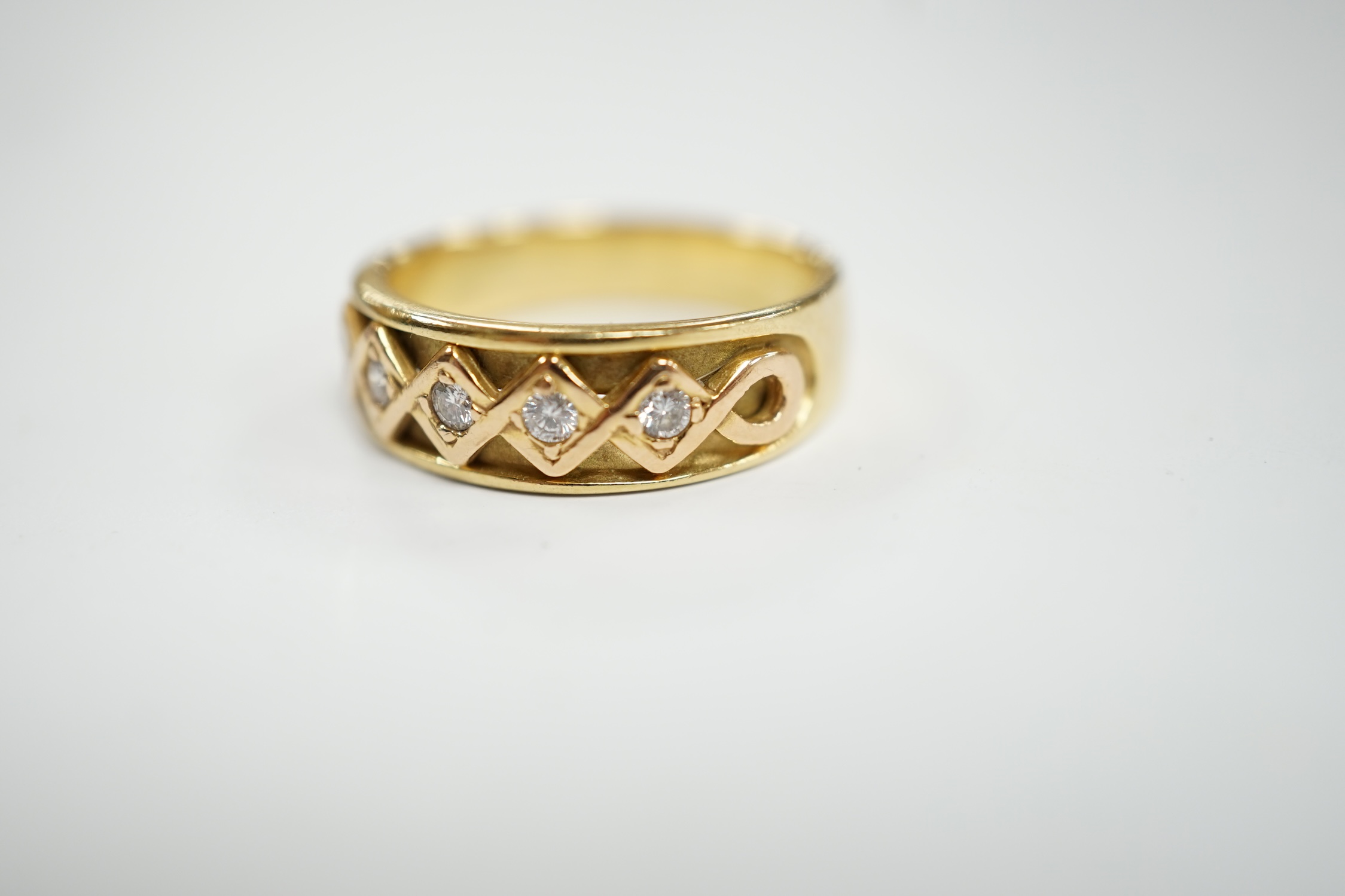 A modern 18ct gold and five stone diamond set half hoop ring, size O, gross weight 6.2 grams.